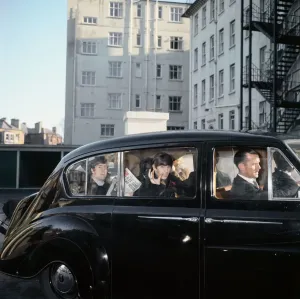 Prints of The Beatles John Lennon and Ringo Starr can be seen in the back of a black limosine being driven along the road in Plymouth. ohn is holding a copy of the Daily Mirror 13th November 1963 Plymouth Prints: The Beatles in Plymouth Print, 1963