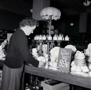 Kensington High Street History Prints: An elderly lady looking for bargains during january sales at Derry
