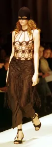 90s Fashion Model Prints: A model models a crochet top and ski mask March 1999 at the Moschino fashion show