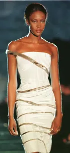 Supermodel Style Inspiration Prints: Naomi Campbell modelling white strapless evening dress as part of Donatella Versace