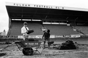 Prints of Fulham manager Malcolm Macdonald with a roll of turf at Craven Cottage as the pitch is re-laid. 12th May 1983 0300to0399 Prints: Fulham Manager Malcolm Macdonald, 12th May 1983 Print