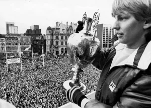 Prints of Aston Villa footballer Gary Shaw shows of the the league Championship trophy to the thousands of supporters who lined the streets of Birmingham to welcome their heroes following their match against Birmingham Prints: Aston Villa Championship Victory Print, 2nd May 1981