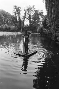 Prints of Black Sabbath rock group pictured enjoying the countryside at Monmouth in the Wye Valley, Wales. Singer Ozzy Osbourne steering a makeshift raft across the river. 10th August 1977 0500to0599 Prints: Black Sabbath in the Wye Valley Print, 10th August 1977