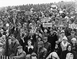 Prints of Sport - Football - Swansea - Swansea fans brave the rain during the FA Cup Semi-Final tie between Swansea Town and Preston North End at Villa Park. - 14th March 1964 0600to0699 Prints: Swansea Fans Brave the Rain - FA Cup Semi-Final Print 1964