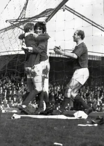 Prints of Wolves 2-4 Manchester United, FA Cup Fifth Round match at Molineux, Denis Law is congratulated on his goal by jubilant teammates George Best (centre) and Bobby Charlton, Saturday 5th March 1966 1000to1099 Prints: Wolves 2-4 Manchester United, FA Cup Fifth Round Print