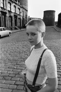 Prints of Seventeen year old skinhead teenager Janet Askham poses in the street at her home in Huddersfield, West Riding of Yorkshire. 6th June 1970 1100to1199 Prints: 1970s Huddersfield Skinhead Print