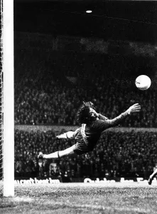 Prints of Pat Jennings Football Arsenal Nov 1977 dives to stop the ball during the Manchester United v Arsenal game at Old Trafford Manchester Prints: Pat Jennings Dives to Stop the Ball at Old Trafford Print