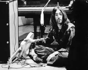 Prints of John Lennon appears at The Natural Music Concert, Lady Mitchell Hall, Cambridge, England in March 1969. In two other frames in this set, he is pictures with Yoko Ono Cambridge Prints: John Lennon at The Natural Music Concert, Cambridge Print 1969