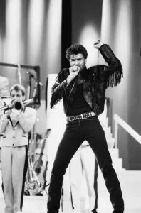Prints of Wham. The Farewell Concert at Wembley Stadium, London England (Picture). George Michael on stage. 28th June 1986 1300to1399 Prints: Wham. Farewell Concert Print at Wembley Stadium 1986