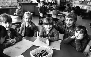 Prints of Head teacher Rita Shreenan with pupils at St Brigids Catholic Primary School, Cantril Farm, Liverpool. 22nd February 1984 Rita Prints: Black and white print of a head teacher with pupils