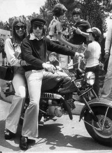 Jackie Stewart Prints: Jackie Stewart and Wife Helen on a Motor Bike Print
