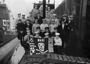 Prints of Home again pictures of the Royal Many submarine HMS Unrivalled which has just returned from a successful patrol in the Mediterranean Sea 1400to1499 Prints: Print of HMS Unrivalled crew with Jolly Roger