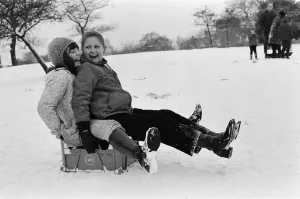 Prints of Children sledging on a milk crate in Greenwich Park, London, 27th December 1970 Weather Prints: Print of Children Sledging on a Milk Crate in Greenwich Park, London
