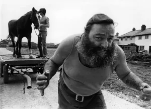 Prints of Haulage contractor Herbie Grindley is set to prove hes stronger than his horse. He plans to put Bess on her cart and pull them both up-hill, using just his shoulder length hair Cheshire Prints: Print of Herbie Grindley's Hair-Pulling Stunt