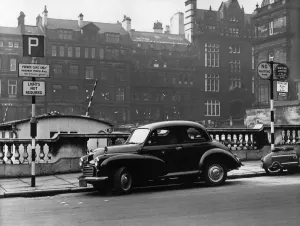 Prints of Morris Minor parked in Crosshall Street, Liverpool, with opposing street signs, on the left, allowing cars to park, on the right, no waiting, 23rd February 1960 1500to1599 Prints: Print of Morris Minor parked in Crosshall Street, Liverpool