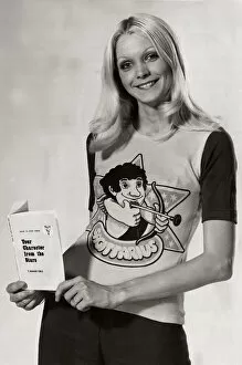 Images Dated 10th February 2005: Model wearing a zodiac sign t-shirt witha cartoon of Sagittarius on it holding a book