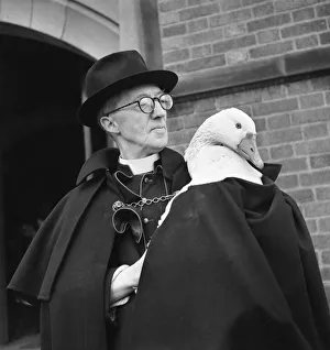 Monsignor Dunne and his pet goose Victor outside the church Monsignor Dunne and his pet goose Victor outside the church