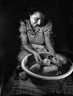 Mother Janet Trayler washing her 4 weeks old baby. August 1943 P009458 Mother Janet Trayler washing her 4 weeks old baby. August 1943 P009458