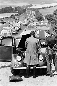 Motor mechanic seen here trying to repair a broken down car as heavy August Bank Motor mechanic seen here trying to repair a broken down car as heavy August Bank