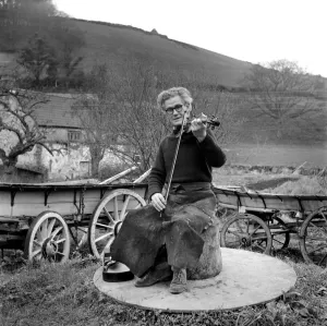 Mr. Harry Horrobin playing his violin outside. January 1975 75-00196 Mr. Harry Horrobin playing his violin outside. January 1975 75-00196