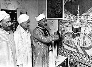 Mr Saleh Hassen of Loudon Square showing a tapestry of Kaaba Mecca to two members of Mr Saleh Hassen of Loudon Square showing a tapestry of Kaaba Mecca to two members of