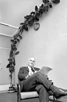 Mr. Wilf Berrill and Giant Rubber Tree Plant (Unusual). January 1975 75-00331 Mr. Wilf Berrill and Giant Rubber Tree Plant (Unusual). January 1975 75-00331