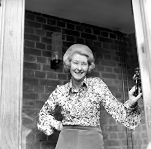 Mrs. Babette Barber looking out of her window. April 1975 75-2155 Mrs. Babette Barber looking out of her window. April 1975 75-2155