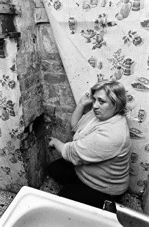 Mrs Mary Wall points out peeling wallpaper and hole in brickwork which she claims was Mrs Mary Wall points out peeling wallpaper and hole in brickwork which she claims was