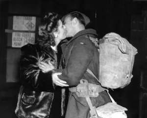 Mrs Wells of Leigh On Sea greets her husband with a kiss at the railway station after Mrs Wells of Leigh On Sea greets her husband with a kiss at the railway station after