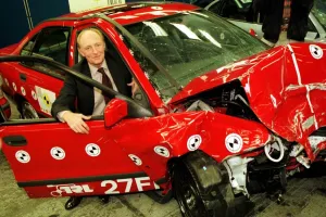 Neil Kinnock EU Commissoner for transport with crashed Volvo at todays EURO NCAP test Neil Kinnock EU Commissoner for transport with crashed Volvo at todays EURO NCAP test