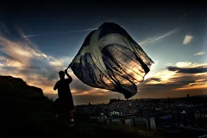 New Dawn September 1997 a man holding waving a Saltire flag at sunrise in Edinburgh New Dawn September 1997 a man holding waving a Saltire flag at sunrise in Edinburgh