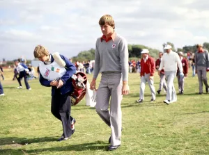 Nick Faldo with his caddy in the background his partner Peter Oosterhuis of the European Nick Faldo with his caddy in the background his partner Peter Oosterhuis of the European