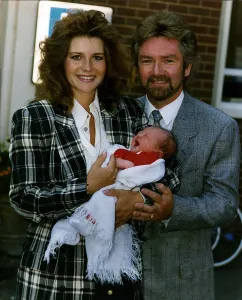 Noel Edmonds Tv Presenter with new born baby Olivia and wife Helen Noel Edmonds Tv Presenter with new born baby Olivia and wife Helen