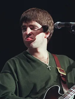 Noel Gallagher Oasis pop group December 1997 Sticking tongue out playing guitar Noel Gallagher Oasis pop group December 1997 Sticking tongue out playing guitar
