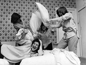 Nolan sisters Maureen flops on the bed under the combined assault of Anne, Left Nolan sisters Maureen flops on the bed under the combined assault of Anne, Left