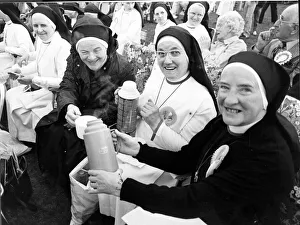 Nuns - Nuns enjoy a cup of tea from their flasks whilst they wait to see the Pope during Nuns - Nuns enjoy a cup of tea from their flasks whilst they wait to see the Pope during