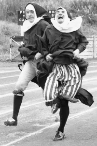 The Nun's Olympics. The 100 metre dash by two nuns in the form of left Kevin Moran The Nun's Olympics. The 100 metre dash by two nuns in the form of left Kevin Moran