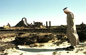 An oil worker walks amongst the wreckage of an oil containment centre destroyed by Iraq An oil worker walks amongst the wreckage of an oil containment centre destroyed by Iraq