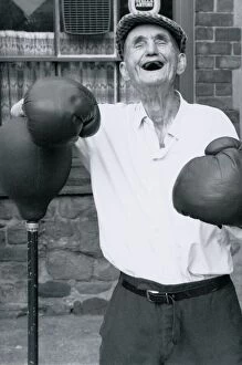 Images Dated 25th August 1988: Old age pensioner Jackie McGuire aged 92 Standing beside punch ball wearing boxing