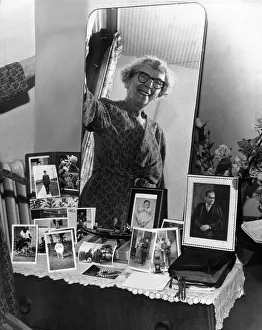 Old woman smiling at bedroom mirror in her newly-built Home. 9th october 1963 Old woman smiling at bedroom mirror in her newly-built Home. 9th october 1963