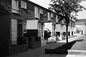 Painted council houses and the unpainted ones - part of a battle of home buying at a Painted council houses and the unpainted ones - part of a battle of home buying at a
