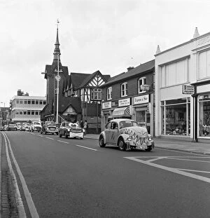 Images Dated 1st June 1974: A parade of cars led by a decorated VW Beetle drive along Bridge Street, Stafford