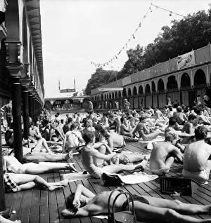 Parisians cool off at The Pont Royal on the banks of the River Seine Parisians cool off at The Pont Royal on the banks of the River Seine