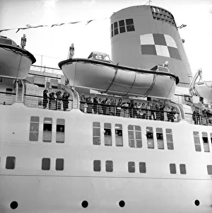 Passengers wave as they stand underneath the lifeboats on the deck of the Empress of Passengers wave as they stand underneath the lifeboats on the deck of the Empress of
