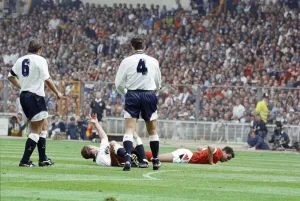 Paul Gascoigne of Tottenham Hotspur Football Club lies on the ground waving to Paul Gascoigne of Tottenham Hotspur Football Club lies on the ground waving to