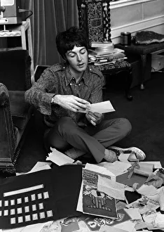 Paul McCartney of The Beatles sitting on the floor cross legged as he opens up birthday Paul McCartney of The Beatles sitting on the floor cross legged as he opens up birthday