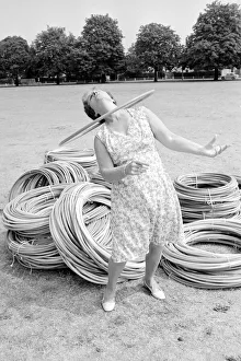 Pensioner playing with Hula Hoops in a Twickenham park . August 1976 P76 734 Pensioner playing with Hula Hoops in a Twickenham park . August 1976 P76 734
