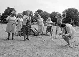 Pensioners playing with Hula Hoops in a Twickenham park . August 1976 P76 734 Pensioners playing with Hula Hoops in a Twickenham park . August 1976 P76 734