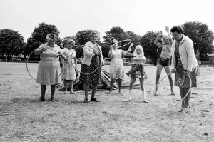 Pensioners playing with Hula Hoops in a Twickenham park, London. August 1976 P76 734 Pensioners playing with Hula Hoops in a Twickenham park, London. August 1976 P76 734