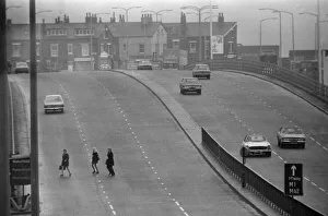 People crossing the motorway dangerously, in the north of England. 8th November 1974 People crossing the motorway dangerously, in the north of England. 8th November 1974